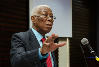 Minister of Foreign Affairs and Foreign Trade, Senator the Hon. A.J. Nicholson, emphasies a  point as he addresses a public forum on the Caribbean Court of Justice (CCJ), held on October 9, at the Faculty of Law, University of the West Indies, Mona.