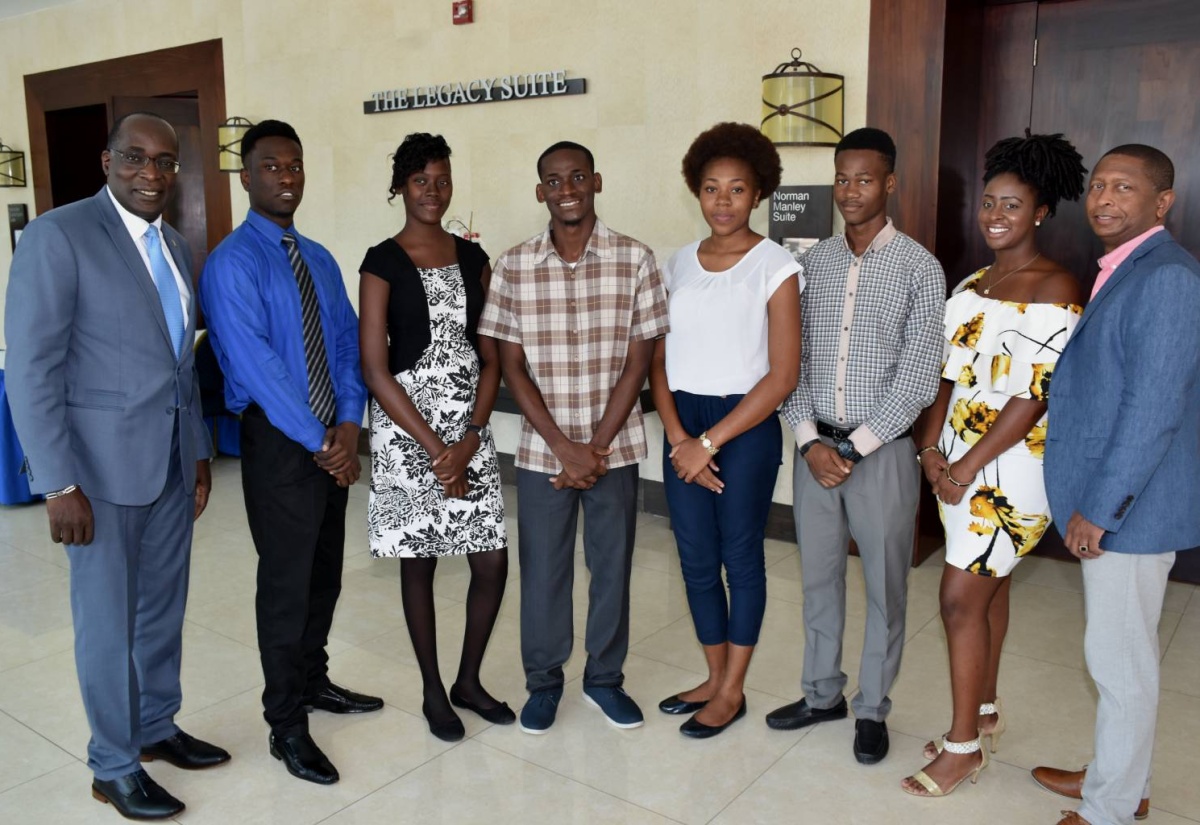 Minister of Education, Youth and Information, Senator the Hon. Ruel Reid (left) and Chairman/Founder, Children of Jamaica Outreach, Inc. (COJO), Gary Williams (right), sharing a moment with the six scholars who have been awarded tertiary-level scholarships totalling US$22,500 by COJO. The presentations were made on Wednesday (September 13) during a luncheon at The Jamaica Pegasus hotel in New Kingston. The scholarship recipients (from second left) are Aaron Rowe, Shantanna Dixon, Nickorta Samuels, Golda-Mae Bullock, Kareem Carr and Chantell Campbell.