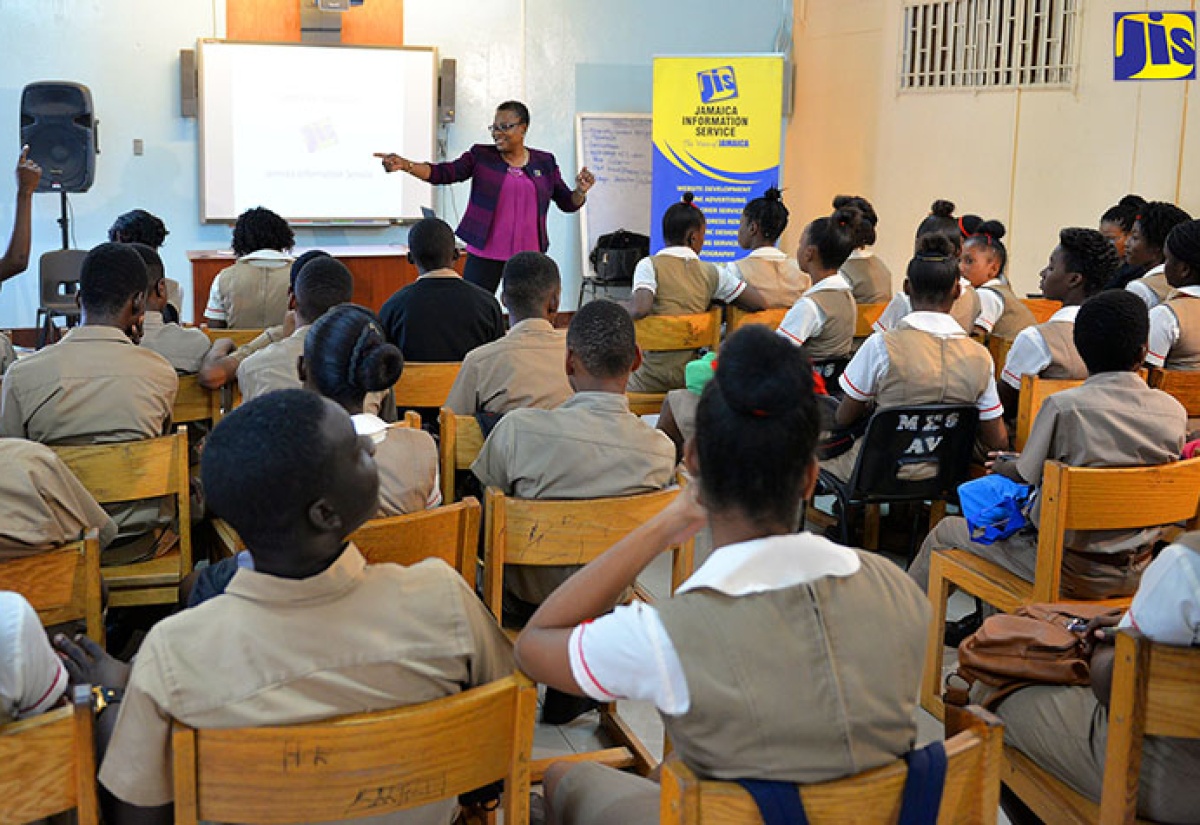 Director of Production, Jamaica Information Service (JIS), Enthrose Campbell, acknowledges a student wanting to answer her question at Mona High School’s recently held Career Day.