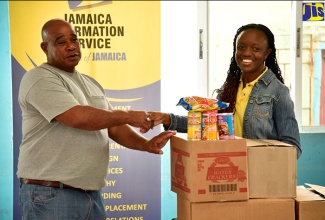 Donations from Lasco Foods are handed over to Director of the Mt. Olivet Boys’ Home in Walderston, Manchester, Patrick Newman, by Special Projects Officer at the Jamaica Information Service (JIS), Christine Ade-Gold, during the Christmas visit on Saturday, December 2. 

