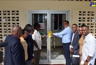 Minister of Health, Dr. the Hon. Christopher Tufton (fourth right), cuts the ribbon to reopen the newly renovated Balaclava Health Centre in St. Elizabeth on Thursday, December 7. Chief Executive Officer of the Culture, Health, Arts, Science and Education (CHASE) Fund, William “Billy” Heaven (third right), parish health officials; and community members look on.