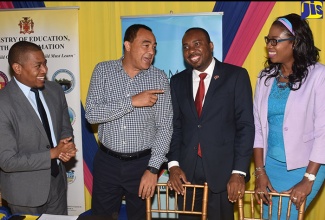 Minister of Health, Dr. the Hon. Christopher Tufton (second left), is in light conversation with (from left): State Minister in the Ministry of Education, Youth and Information, Hon.  Floyd Green; Caribbean Regional Director, AIDS Healthcare Foundation, Dr. Kevin Harvey; and Acting Director, Health Services, Planning and Integration in the Ministry of Health, Dr. Simone Spence. Occasion was the launch of ‘Teen Hub’ on November 28, at the Half-Way Tree Transport Centre, St. Andrew.