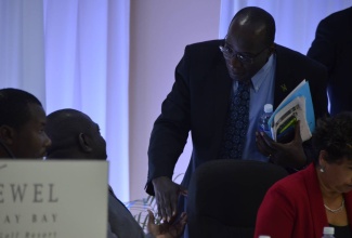 Minister of Education, Youth and Information, Senator the Hon. Ruel Reid (right), is greeted by Jamaica Teachers’ Association (JTA) President, Norman Allen (second left),  at the JTA’s  15th Annual Education Conference, held at the Jewel Runaway Bay Beach and Golf Resort, in  St. Ann, on March 29.