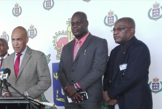 Commissioner of Police, Major General Antony Anderson (at mike), addresses press briefing at the Montego Bay Convention Centre, Rose Hall, St. James, on May 3.  Listening keenly are Assistant Commissioner of Police (ACP) in charge of the Counter-Terrorism and Organised Crime (C-TOC) Branch, Fitz Bailey (second right); Assistant Commissioner of Police (ACP), Operations, Bishop Dr. Gary Welsh (right), and Deputy Commissioner of Police (DCP) in charge of Crime, Selvin Hay.