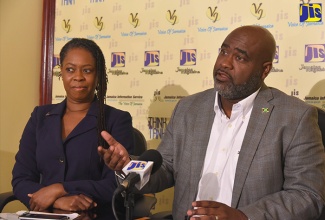 Senior Advisor in the Ministry of Science, Energy and Technology, Trevor Forrest, addresses a Think Tank at the Jamaica Information Service (JIS) head office in Kingston recently. At left is Head of the Cyber Incident Response Team (CIRT), Dr. Moniphia Hewling.