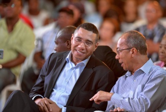 Prime Minister, the Most Hon. Andrew Holness (left), converses with Minister without Portfolio in the Ministry of Economic Growth and Job Creation, Hon. Dr. Horace Chang, during the inaugural ‘HOPE for Jamaica’ town hall meeting at the Ocho Rios High School in St. Ann on Thursday, May 4.