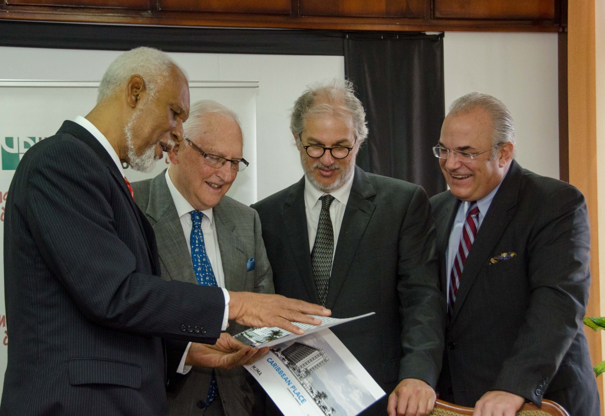 Chairman of the Urban Development Corporation (UDC), Senator the Hon. K.D. Knight (left), discusses the development plans for the Oceana Hotel with (from second left)  Chairman of the Canadian-based Downing Street Group, Anthony Alberga; Chairman, Pan Jamaica (Pan Jam) Stephen Facey; and President of the Downing Street Group, Daniel Odorico. Occasion was the signing of the official sales agreement for the property, which has been sold by the UDC for $385 to Jamaican-Canadian consortium, King Church Property Holdings Ltd. The consortium comprises which comprises Canadian real estate developers, Downing Street Partners Realty, and Jamaica Property Company Ltd, which is a member of the Pan Jam Group. The event took place on Tuesday (Nov.18), at the UDC’s offices in downtown Kingston.  