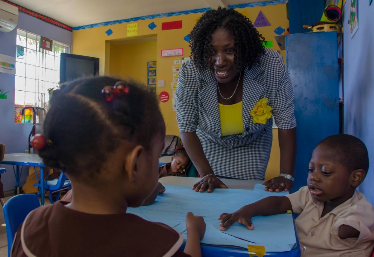 Director of the Early Stimulation Programme (ESP), Mrs. Antonica Gunter-Gayle, interacts with young children enrolled in the programme, at the Stimulation Plus (STIM-PLUS) Child Development Centre, in Kingston.