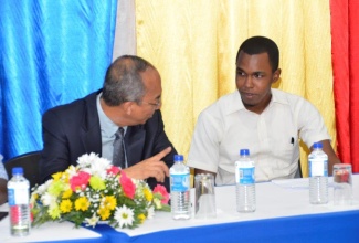 Minister without Portfolio in the Ministry of Economic Growth and Job Creation, Hon. Dr. Horace Chang (left), converses with Glendevon, St. James native and newly trained medical practitioner, Dr. Jason Bowen, during an awards ceremony hosted by the University of the West Indies Western Jamaica Campus in Montego Bay on August 24. Dr. Bowen is past beneficiary of the student bursary assistance programme, initiated by Dr. Chang in North West St. James for which he is the Member of Parliament. 