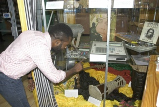 Keeper of Collection, Institute of Jamaica (IOJ),  Jason Ramsay, points to a drum machine donated by Lowell “Sly” Fillmore Dunbar to the Jamaica Music Museum. The musical instrument is one of the many pieces on display at the Jamaica Information Service’s (JIS) head office, 58 Half-Way Tree Road, Kingston in observance of Reggae Month under the theme: ‘Reggae Mecca.’