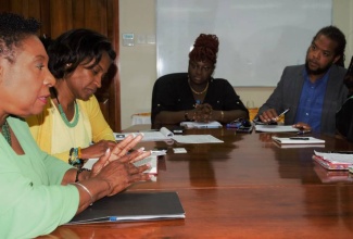 The Honourable Olivia Grange, Minister of Culture, Gender, Entertainment and Sport (left) in discussion with Karen Smith, President of the Jamaica Federation of Musicians and Affiliates Union (right), members Suzanne Brooks-Riba, Rory Frankson and Marsha Kennedy (from 2nd right to left) during a recent meeting. Senior Director of Entertainment in the Ministry, Gillian Wilkinson-McDaniel (2nd left) was also a part of the meeting which was held at the Ministry on Trafalgar Road.