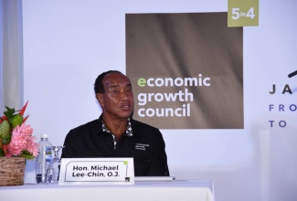 Economic Growth Council (EGC) Chairman, Michael Lee-Chin, delivering the EGC’s third quarterly report at the Spanish Court Hotel in New Kingston on Thursday, July 27.