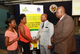 Jamaica Anti-Doping Commission (JADCO) Chairman,  Alexander Williams (2nd right), converses with parent, Maxine Taylor (2nd left), during Thursday’s (April 6) launch of the JADCO/National Parent-Teacher Association of Jamaica Anti-Doping parents education workshop at the Karl Hendrickson Auditorium, Jamaica College, St. Andrew. Others from left are fellow parent, Tracey-ann Graham Alonso and JADCO Executive Director, Carey Brown.