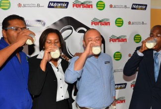 Chief Executive Officer (CEO), Jamaica Dairy Development Board (JDDB), Hugh Graham (right); is joined by (from left) CEO, Seprod Group of Companies, Richard Pandohie; Business Development Manager, Newport Fersan Jamaica Limited, Hedda Rose Pitter; and Chief Operating Officer, CB Group, Matthew Lyn, in consuming glasses of milk during the launch of the ‘Drink Real Milk’ campaign at the Terra Nova All Suite Hotel in St. Andrew today (Jan. 28). 