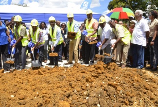 Prime Minister, the Most Hon. Andrew Holness (centre), breaks ground on Friday, March 10, for the development of 32 services lots in Darliston, eastern Westmoreland. The project is being undertaken by the National Housing Trust (NHT) at a cost of $95.4-million. Joining Mr. Holness are NHT Chairman, Ambassador Dr. Nigel Clarke (3rd left); eastern Westmoreland Member of Parliament, Luther Buchanan (4th right), as well as other government and agency representatives.