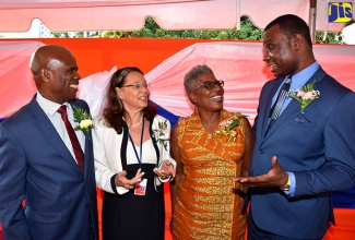 Permanent Secretary in the Ministry of Education, Youth and Information, Dean-Roy Bernard (right), speaking with (from left) Custos Rotulorum of Kingston, Hon. Steadman Fuller; Deputy Principal, UWI Open Campus, Professor Julie Meeks Gardner; and Campus Registrar, UWI Open Campus, Karen Ford-Warner. Occasion was the launch of a photo exhibition entitled ‘The UWI –Then and Now… Riding on the Shoulders of Giants’ at the Open Campus on Camp Road, Kingston, on April 9.

