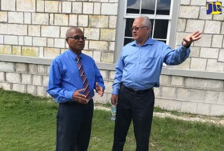 Minister of Justice, Hon. Delroy Chuck (right), speaks with the Custos of Portland,  Hon. Lincoln Thaxter, at the  Lay Magistrates’ Association of Jamaica, Portland Chapter’s annual general meeting, held on Friday (January 26), in Buff Bay, Portland.