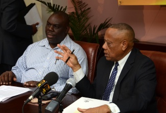 Acting Agriculture and Fisheries Minister, Hon. Derrick Kellier (right), addresses the launch of  the National Irish Potato Expansion Programme 
today (September  30), at the the Ministry’s Hope Gardens headquarters, in Kingston. Mr. Kellier also outlined plans for the 2014/15 crop season. At left is Permanent Secretary in the Ministry, Donovan Stanberry.
