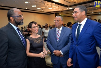 Prime Minister, the Most Hon. Andrew Holness (right), in discussion with (from left) Chairman, Jamaica 55 Diaspora Conference, Earl Jarrett;  Minister of Foreign Affairs and Foreign Trade, Senator the Hon. Kamina Johnson Smith; and Leader of the Opposition, Dr. Peter Phillips. Occasion was the opening ceremony for the Jamaica 55 Diaspora Conference, at The Jamaica Pegasus hotel in New Kingston, on July 23.