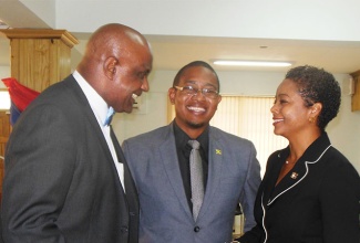 State Minister for Education, Youth and Information, Hon. Floyd Green (centre), engages Attorney General, Hon. Marlene Malahoo Forte (right), and Caribbean Maritime Institute (CMI) Executive Director, Dr. Fritz Pinnock, in conversation during the launch of the CMI/Sam Sharpe Teachers’ College Campus in Granville, St. James on April 7. The campus is located in West Central St. James for which Mrs. Malahoo-Forte is the Member of Parliament.