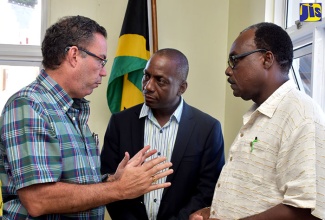 Minister without portfolio in the Ministry of Economic Growth and Job Creation, Hon. Daryl Vaz (left), has the attention of Executive Director of the National Solid Waste Management Authority (NSWMA), Audley Gordon (centre); and Mayor of Port Antonio, Councillor Paul Thompson,  at a  town hall meeting held at the Portland Municipal Corporation in Port Antonio on Tuesday (January 3).