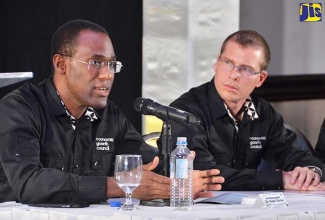 Economic Growth Council (EGC) Deputy Chairman, Ambassador Dr. Nigel Clarke (left), addresses the EGC’s quarterly briefing at The Jamaica Pegasus hotel in New Kingston on January 26.  At right is EGC member, Adam Stewart.
