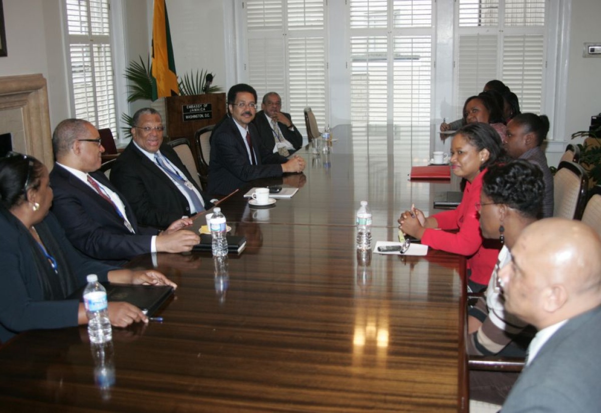 Minister of Finance and Planning, Dr. the Hon. Peter Phillips (third left), addresses staff members  of the embassy of Jamaica in Washington, D.C.,  on October 11.  To the Minister’s right is Governor of the Bank of Jamaica (BOJ), Brian Wynter  and to his left is Ambassador to the United States, His Excellency Stephen Vasciannie.