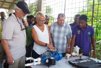 German Ambassador to Jamaica, Joachim Christoph Schmillen; Head of the European Union Delegation to Jamaica, Ambassador Malgorzata Wasilewska; and Finance and Public Service Minister, Hon. Audley Shaw, pay keen attention as a student explains how to repair a weed whacker. Occasion was the recent launch of the  Sugar Transformation Unit’s (STU) skills training programme at the Jamaica 4-H Clubs Training and Production Centre in Clarendon. 