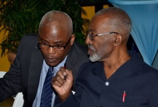 National Housing Trust (NHT) Chairman, Easton Douglas (right), conversing with National Environment and Planning Agency (NEPA) Chief Executive Officer, Peter Knight, during a public lecture and exhibition held as part of a series of activities in observance of World Town Planning Day, being observed today (November 8),  at the NHT’s New Kingston offices, on Friday (November 7).