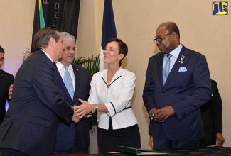 Foreign Affairs and Foreign Trade Minister, Senator the Hon. Kamina Johnson Smith (second right), shakes hands with Tourism Minister of the Dominican Republic, His Excellency, Francisco Javier Garcia (left), just before the signing of the multi-destination agreement between the countries at the Jewel Grande Resort and Spa in St. James on November 28. Others looking on are Tourism Minister, Hon. Edmund Bartlett (right); and Foreign Affairs Minister of the Dominican Republic, His Excellency Miguel Vargas Maldonado.