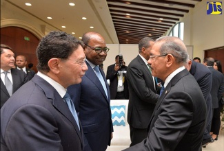 Tourism Minister, Hon. Edmund Bartlett (centre), looks on as Secretary General of the United Nations World Tourism Organisation (UNWTO), Dr. Taleb Rifai (left), greets President of the Dominican Republic, His Excellency Danilo Medina Sánchez. Occasion was the opening ceremony for the UNWTO Global Conference on ‘Jobs and Inclusive Growth: Partnerships for Sustainable Tourism’, at the Montego Bay Convention Centre in St. James on November 28.