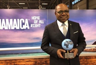 Tourism Minister, Hon. Edmund Bartlett, with his Global Award at the ITB in Berlin Trade Show.