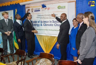 Minister of Science, Energy and Technology, Dr. the Hon. Andrew Wheatley (centre), officially launches the Sustainable Energy and Climate Change Master’s Degree Programme at the University of Technology (UTech), yesterday  (March 2) at the school’s Papine campus. Others (from left) are Charge d’Affaires at the  German Embassy, Michael Dumke; Dean, Faculty of the Built Environment at  UTech, Dr. Garfield Young; President of  UTech, Professor Stephen Vasciannie, CD.; UTech’s Sustainable Energy Head, Dr. Ruth Potopsingh; Manager, Energy, CARICOM Secretariat, Dr. Devon Gardner, and Representative from the German Society for International Cooperation (GIZ) in the Dominican Republic, Anya Shwerwin.