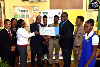 Executive Director, Scientific Research Council (SRC), Dr. Cliff Riley (3rd right), accepts a cheque for $170,000 from NCB Matilda’s Corner Branch Manager, Dave Wilson (4th left), at the SRC’s Hope Road Office on August 10. The funds will go towards expanding the ‘Energy For Young Minds’ (EFYM) programme of the SRC’s Caribbean Energy Information System (CEIS) Department. Others pictured (from left) are Team Leader for the CEIS, Curtis Deenah; Manager for the Information Services Division at the SRC, Kerry-Ann Curtis; Technical Information Officer, CEIS, Carol Davis; Kingston High School student, Alethia Thompson; Ardenne High School students Nicholi Bogues and Fabrizio Darby; and St. Hugh’s High School student, Oshen Constable.