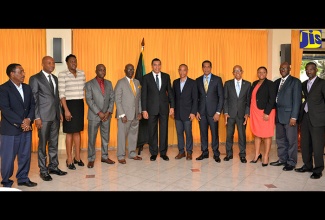 Prime Minister the Most Hon. Andrew Holness (centre); Minister of Local Government and Community Development, Hon. Desmond McKenzie (fifth left); and Board Chairman of the National Solid Waste Management Authority (NSWMA), Dennis Chung (6th right), share a photo opportunity with the recently announced Enterprise Team charged with identifying a preferred waste management provider for the Riverton Landfill. Occasion was a press conference held at the Office of the Prime Minister on Monday, October 31 to announce the members of the team.