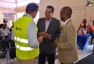 Director of the Meteorological Service of Jamaica, Evan Thompson (right), listens  as His Worship the Mayor of Montego Bay, Homer Davis (centre) makes a point to Chief Executive Officer, MBJ Airports Limited, Dr. Raphael Echevarne,  at the Caribbean Hurricane Awareness Tour (CHAT), held at the Sangster International Airport in Montego Bay, St. James, on April 27. 

