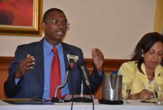 State Minister in the Ministry of Foreign Affairs and Foreign Trade, Hon. Arnaldo Brown (left), provides details about the upcoming  Biennial Jamaica Diaspora Conference at a forum held on May 27 at the Sunset Resort in Montego Bay. At right is Minister of State in the Ministry of Industry, Investment and Commerce, Hon. Sharon Ffolkes-Abrahams.
