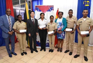 President of the Caribbean Maritime University (CMU), Professor Fitz Pinnock (left), Ambassador of the People’s Republic of China, His Excellency, NIU Qingbao (3rd left) and Chief Education Officer, Dr. Grace McLean (3rd right), pose with scholarship awardees following a presentation ceremony held at the CMU, Palisadoes campus on January 26. The recipients are from (2nd left): Nakalia Thompson, Shannon McCalla, Nailah Steele, Winston Chambers, and Courtney Johnson.

