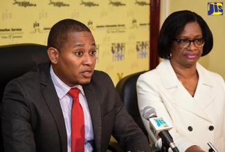 State Minister in the Ministry of Education, Youth and Information, Hon. Floyd Green, addresses  JIS ‘Think Tank’, on  March 14.   At right is Executive Director of the Students’ Loan Bureau (SLB), Ms. Monica Brown.