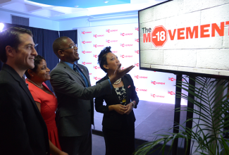 State Minister in the Ministry of Education, Youth and Information, Hon. Floyd Green (second right), looks at the logo for the Movement, an initiative launched by Red Stripe, in collaboration with the Ministry, on March 17, to tackle underage drinking by engaging students from 30 high schools through the use of a live theatre production. He is accompanied by (from left) Red Stripe Managing Director, Mr. Ricardo Nuncio; Director of Client Services at the National Council on Drug Abuse (NCDA), Mrs. Collette Kirlew-Browne; and Head of Corporate Relations at Red Stripe, Mrs. Dianne Ashton-Smith. The project was launched at  Red Stripe’s Spanish Town Road location.