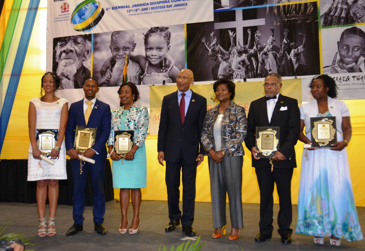 Their Excellencies, Governor-General, the Most Hon. Sir Patrick Allen (centre), and Lady Allen (3rd right), with five of the six members of the Jamaican Diaspora who received the 2015 Governor General's Award for Excellence, following the presentation ceremony at the Montego Bay Convention Centre in St. James on June 16. The awardees (from left) are: Lisa Soares (United States of America); Nathaniel Peat (United Kingdom); Claudette Powell (USA), and Kingsley Gilliam and Michelle Brumley (Canada). The award for the sixth recipient, Gloria Leslie, who is based in the United Kingdom, and who was absent, was collected by Jamaica’s High Commissioner to the UK, Her Excellency, Aloun Ndombet Assamba. The ceremony formed part of activities marking Diaspora Day at the conference, which will end on June 18. 