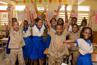 Students of Holy Childhood Preparatory jump for joy after sitting their final paper in the Grade Six Achievement Test (GSAT).