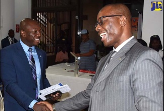 State Minister in the Ministry of National Security, Senator the Hon. Pearnel Charles Jr. (left), is greeted by Assistant Commissioner of Police, Clifford Chambers, at the Small Business Association of Jamaica (SBAJ) Biz Social, held on January 31 at the Petroleum Corporation of Jamaica (PCJ) offices in Kingston. The SBAJ Biz Social was held under the theme: ‘Impact of Crime on Small Businesses’.  