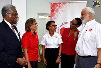 Heart Foundation Board member, Maurice Anderson (left); Executive Director of the Foundation, Deborah Chen (second left); Consultant Cardiologist and Chair of the Foundation, Dr. Andrene Chung (third left) and Sports Medicine Specialist, Dr. Paul Wright (right), in conversation with Acting Director of Health Promotion and Protection in the Ministry of Health, Dr. Beverley Wright (second right), during the media launch for Heart Month (February) on January 24 at the Spanish Court Hotel in Kingston.