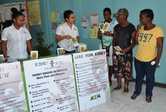 Representatives from the Jamaica Kidney Care Foundation speak with parents at the Spanish Jamaican Foundation’s back-to-school health and information fair at the Spot Valley High School in St. James on Friday (August 21).
