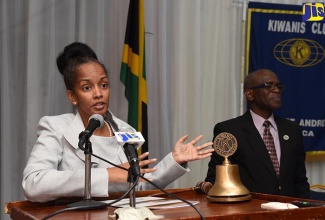 Deputy General Manager, Urban Development Corporation, Heather Pinnock (left), addresses Kiwanis Club of North St. Andrew's weekly meeting at the Police Officers' Club in Kingston on Thursday (January 18). At right is the Club's 1st Vice President,  Kenton Bryan.