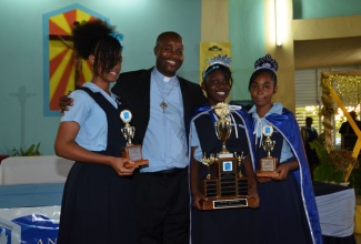 Chairman of the Holland High School in Martha Brae, Trelawny, Father Carl Clarke, celebrates with top academic performers (from left)  Jodi-Ann Dyer (third place); Tasheena Burrell (first place) and Shanneeka Powell (second place). Occasion was the annual prize giving ceremony held on Tuesday, November 26, at the school in Martha Brae, Trelawny.
