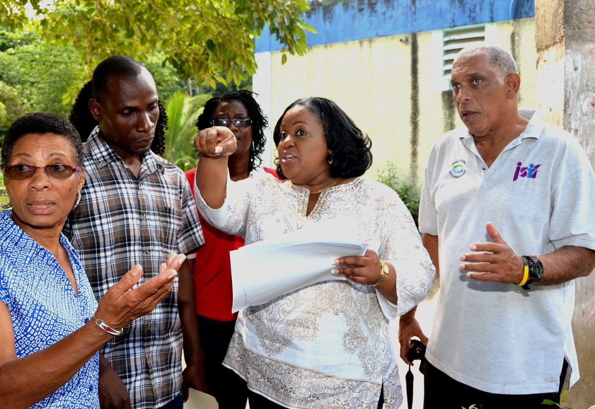 Member of Parliament for North Central St. Catherine, and Minister with responsibility for Sport, Hon. Natalie Neita Headley (second right), engages in discussions regarding the proposed site for a new $5million modern bathroom facility to be built at the St. Mary’s All-Age School in Above Rocks, St. Catherine. Participating in the discussions with (from left) are: Immediate Past Principal of the school, Doreen Rowe; Acting Principal of St. Mary’s All-Age School,  Melbourne Thompson; and Project Officer, Jamaica Social Investment Fund (JSIF), Gerald Murray. The Minister was conducting a site visit of the school on Tuesday (February 17). Scheduled to get underway within three months, the project is being implemented by JSIF through funding by the PetroCaribe Fund.