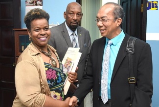 Newly appointed Minister of National Security, Hon. Dr. Horace Chang (right), is welcomed by Permanent Secretary in the Ministry, Dianne McIntosh (left), when he arrived at the Ministry’s St. Andrew offices on March 28. Also sharing in the moment is Minister of State in the Ministry, Hon. Rudyard Spencer.