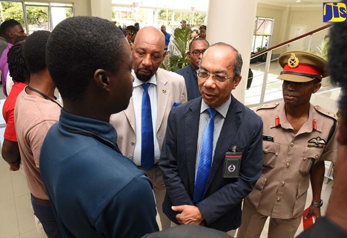 Minister of National Security, Hon. Dr. Horace Chang (second right), speaks with young men who are benefiting from training in various skill areas with the Jamaica Defence Force (JDF). Occasion was a tour of Up Park Camp on April 6.  He was accompanied by Minister of State, Hon. Rudyard Spencer (third right); and Chief of Defence Staff, Major General Rocky Meade (right). 

